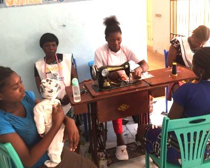 Group of girls using sewing machines to sew cloths