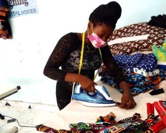 Agirl ironing in a tailoring workshop
