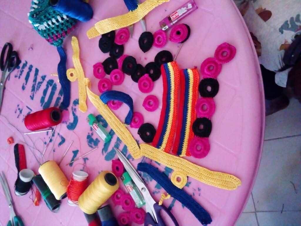 table with threads, needles and products produced