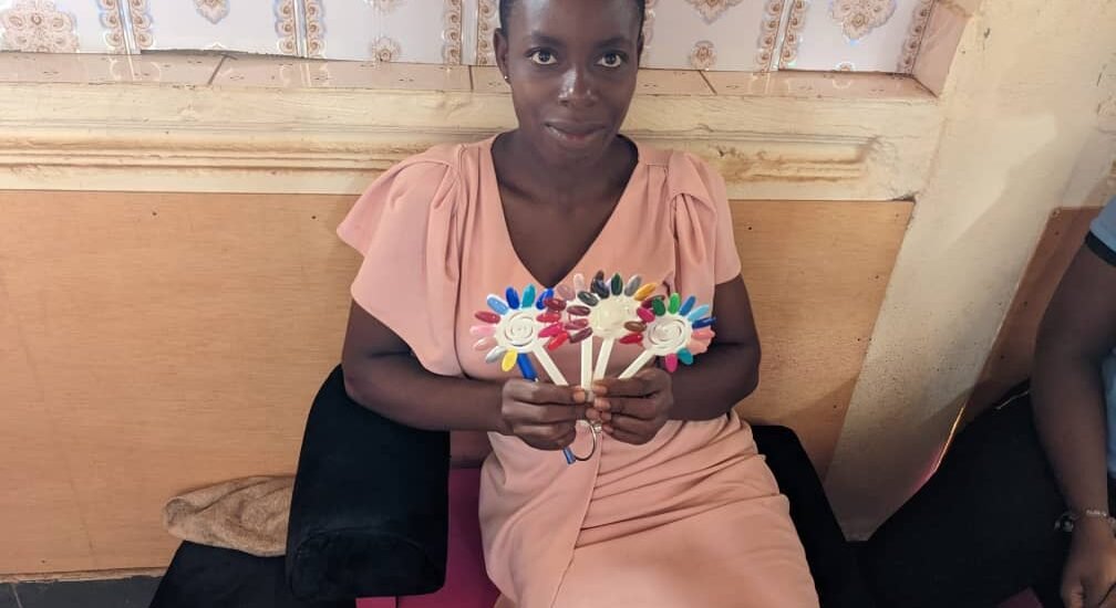 child displaying a product made from hand sowing