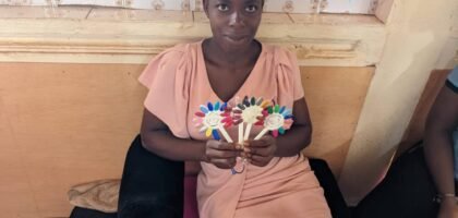 child displaying a product made from hand sowing