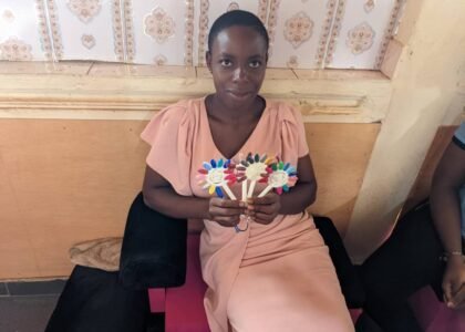 child displaying a product made from hand sowing