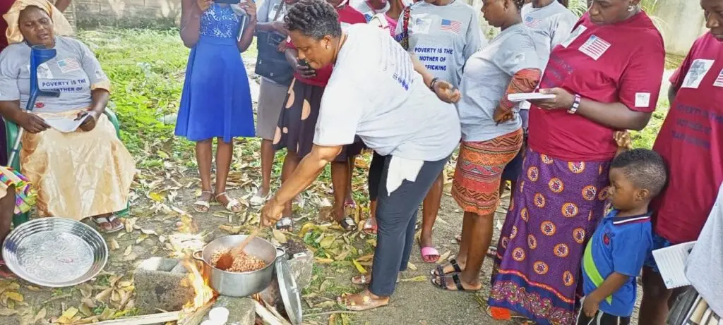 Woman demostrating how to cook in an outer space in a gathering of other women